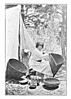 A BASKET MAKER.<BR>
She is weaving a burden basket. The one to the left is for cooking, and a baby basket stands against the tent.